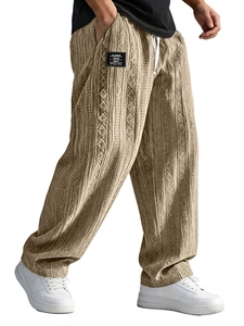 Detail of oat-colored knitted jogger pants featuring waffle texture and drawstring waist