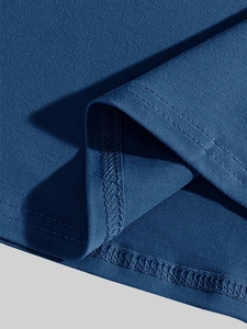 Close-up of blue knit fabric showing durable double-needle stitching and inner overlock seam