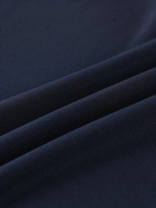 Dettaglio del tessuto a maglia blu scuro con trama a rete traspirante e di alta qualità