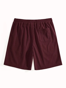 Detailed close-up of burgundy waffle knit shorts with elastic waist and back pocket