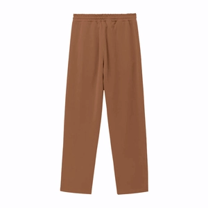 Detail of dark brown straight leg trousers with elastic drawstring waistband