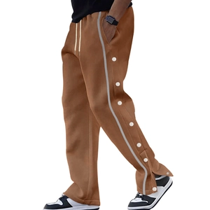Detail view of caramel brown joggers featuring white side snap buttons and drawstrings