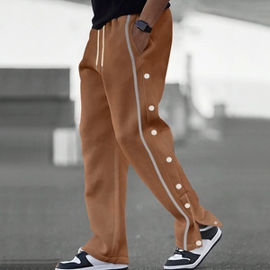 Close-up of men's brown jogger pants with white side stripes and metal snap buttons