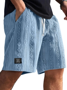 Close-up of men's knit shorts with diamond cable texture and Classic Wear logo patch