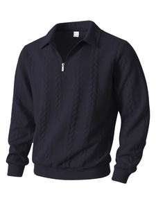 Detail of navy blue cable knit texture and metal quarter-zip collar on men's sweater