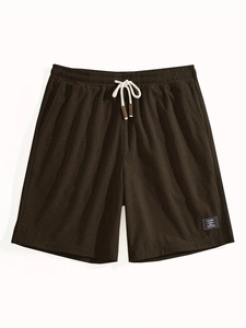 Detail view of coffee brown waffle knit texture and drawstring waist on casual shorts