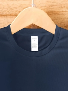 Close-up of navy blue polyester T-shirt neckline with S size label and mesh texture