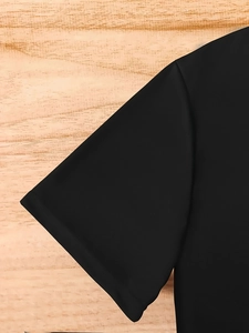 Detail shot of black short sleeve T-shirt cuff with premium knit texture on wood background