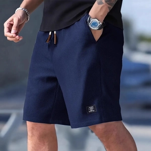 Men's navy waffle knit shorts with elastic drawstring waist and athletic fit