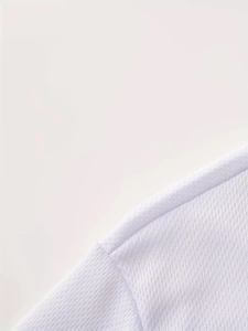 Detail view of white breathable mesh fabric with smooth shoulder stitching for men's tee