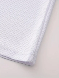 Close-up of men's white breathable mesh T-shirt hem with professional double-needle stitching
