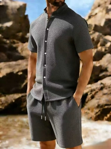 Close-up of charcoal gray waffle fabric texture on men's casual shorts and short sleeve shirt