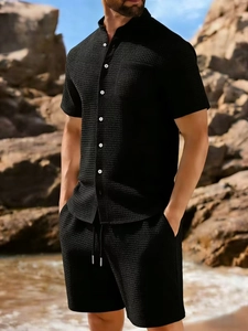 Detail of black waffle knit texture on men's short sleeve shirt and matching drawstring shorts