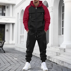 Detail of hooded patchwork jacket and cargo pants with multiple pockets on a male model