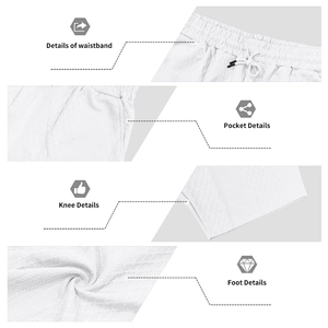 Detail of men's white shorts featuring textured knit fabric and drawstring elastic waist