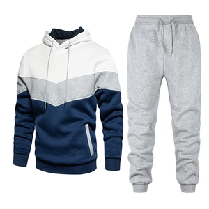Detail of men's tracksuit showing color block hoodie and matching joggers with drawstrings
