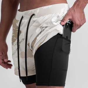 Men's athletic shorts detail showing dual-layer design with compression liner and secure pocket.