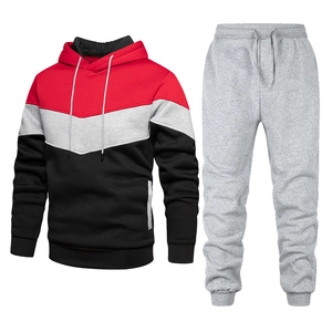 Detail of men's tracksuit showing the V-shaped color-block hoodie and matching jogger pants