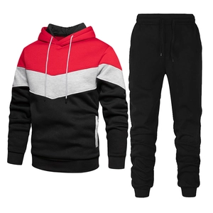 Detailed flat lay of men's color-block tracksuit with red, grey, and black panels