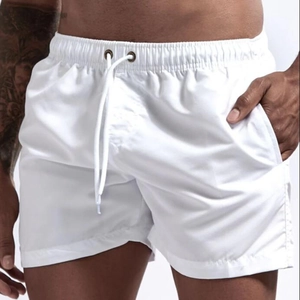 Detail of white quick-dry beach shorts with elastic drawstring waist and metal eyelets