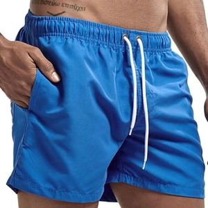Detail of light blue quick-dry men's swim shorts with elastic waist and white drawstring