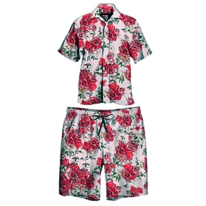 Detail of loose Hawaiian summer set featuring red rose print on white casual shirt and shorts