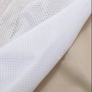 Macro detail of white breathable mesh lining on men's quick-dry swim shorts