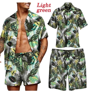 Detail of light green Hawaiian floral print men's beach shirt and drawstring shorts