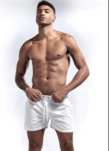 Detail of men's white quick-dry swim shorts featuring elastic waistband and metal eyelets
