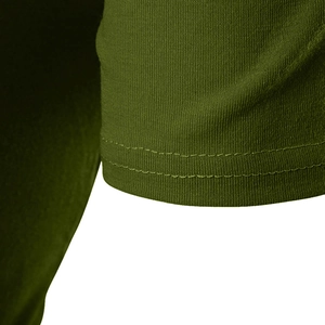 Detailed close-up showing the precise double-needle stitching on green knit fabric hem