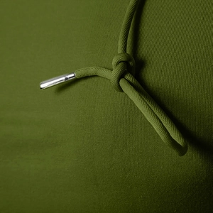 Detail of olive green hooded t-shirt with braided drawstrings and silver metal tips