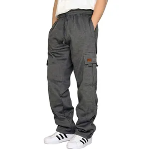 Detail of dark grey fleece cargo joggers featuring a side flap pocket with leather badge