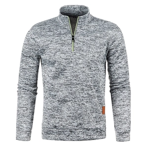 Detail view of heather grey half-zip sweatshirt with neon trim and leather hem tag