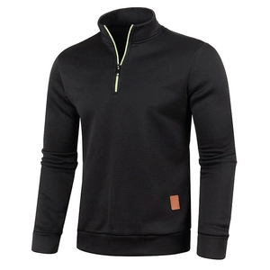 Detail of half-zip stand collar on black sweatshirt with vibrant green zipper accents