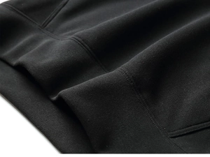 Close-up of high-density black knit fabric with reinforced double-needle stitching details