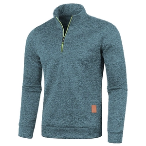 Detail of grey-blue knit sweater showing 1/4 zipper with neon green accent and leather patch