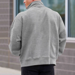 Close-up of the grey half-zip sweatshirt featuring soft brushed texture and dropped shoulders