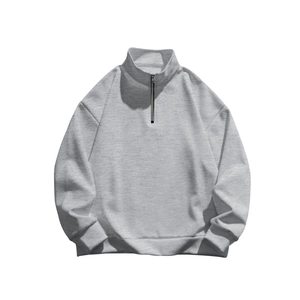 Detailed close-up of high-quality light grey knitted fabric with a sturdy metal half-zipper