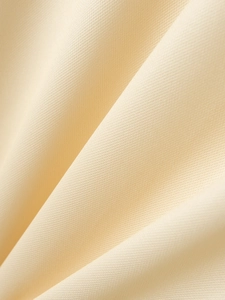 Close-up of beige knit fabric texture on men's polo shirt showing fine weave detail