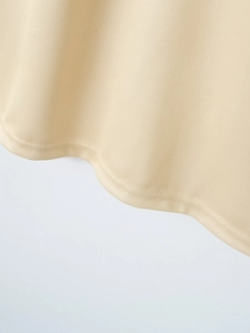 Close-up of beige twill fabric texture and stitching detail on a men's polo shirt