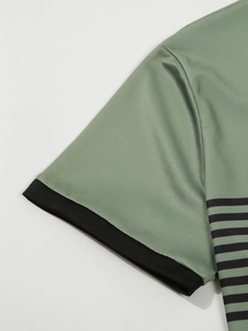 Detail of sage green polo shirt featuring breathable mesh fabric and black ribbed cuff sleeve