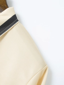 Detail view of the breathable pique fabric texture and striped collar on the men's polo shirt