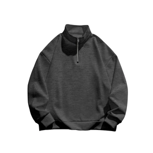 Detail view of dark grey half-zip sweatshirt with stand collar and ribbed cuffs