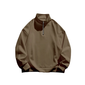 Detail of the stand collar and metal half-zipper on the brown fleece sweatshirt