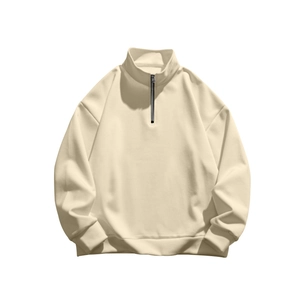 Detail view of cream stand-up collar sweatshirt with contrasting black zipper and ribbed cuffs