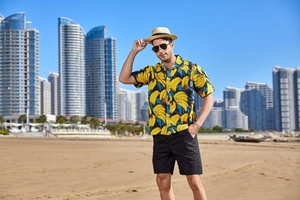 Close-up of men's summer shirt with banana print, Cuban collar and casual beach shorts