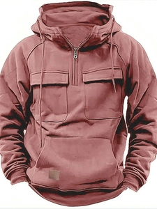 Detail of men's hooded sweatshirt featuring half-zip collar and multiple utility pockets