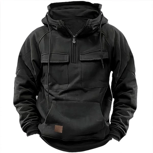 Detail of black hoodie featuring tactical cargo pockets and brown leather patch
