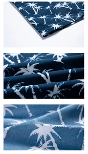 Detail view of tropical palm tree print and stitching on navy blue summer beach shirt