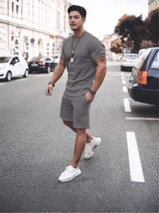 Men's grey casual summer set featuring a short sleeve t-shirt and drawstring shorts outdoors